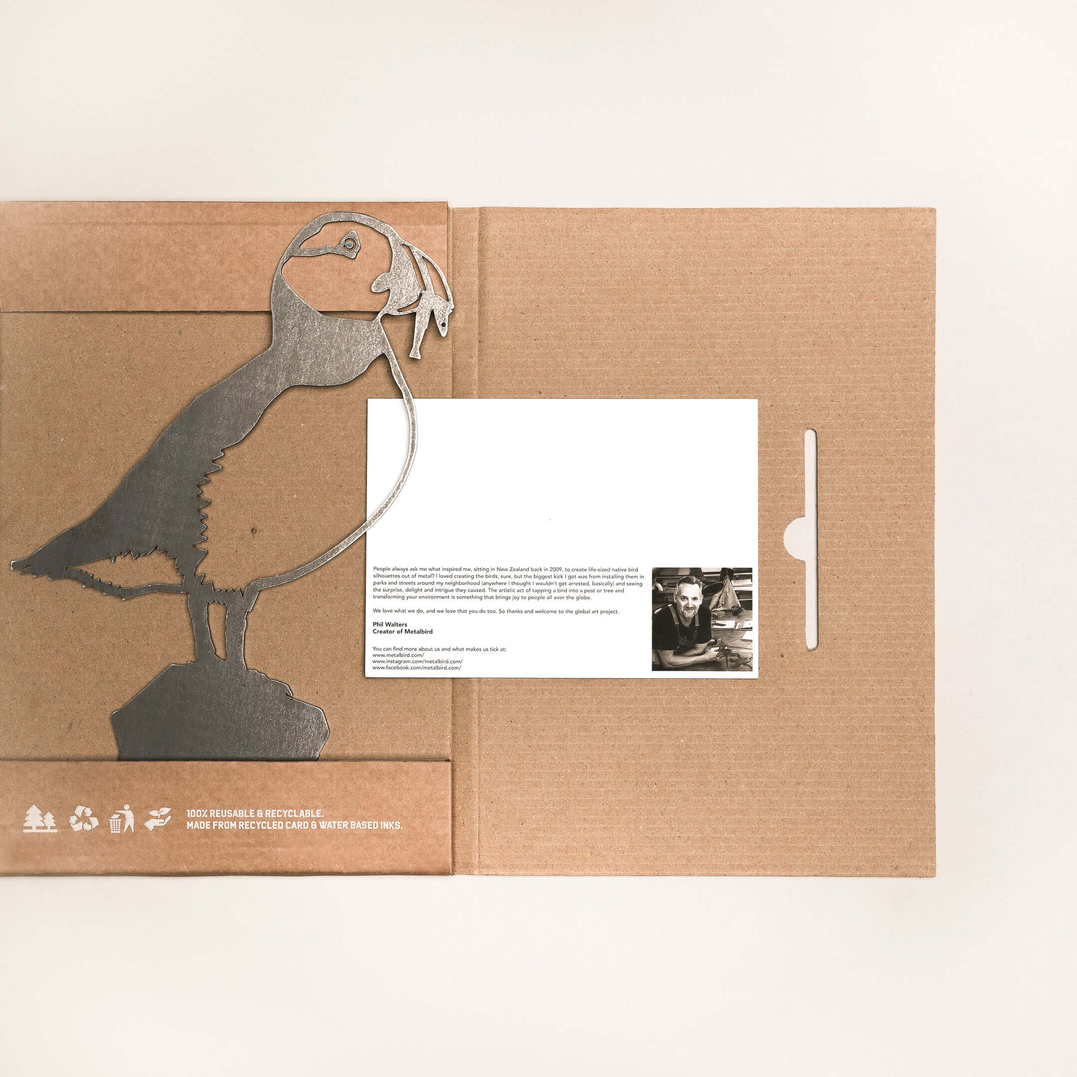 Puffin is a premium cardboard folder featuring a metallic puffin cutout on the left and an inserted white card with text and a black-and-white photo on the right—an elegant gift for any occasion.