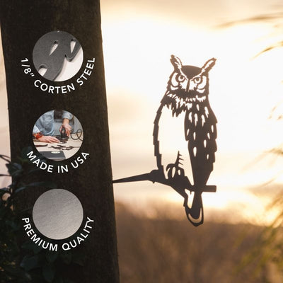 8" corten steel, made in the USA, and showcases premium quality. Attached to a tree, this striking yard decor features a sunset and softly blurred foliage in the background.