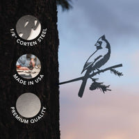 A Cardinal bird silhouette, crafted from 1/8" Corten steel, is mounted on a tree branch to create eye-catching metal bird garden decor. Three circles emphasize its standout features: 1/8" Corten steel construction, made in the USA, and premium quality. Set against a sunset sky background, this Cardinal yard art makes a delightful focal point for any outdoor space.