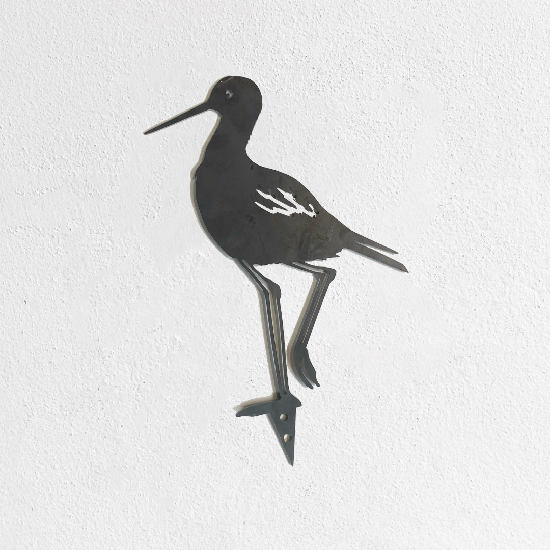 The Metalbird Seconds - Black Stilt features a striking metal bird with a long beak standing on one leg. As part of our exclusive seconds collection, this piece may have minor cosmetic imperfections.