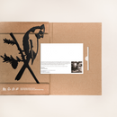 Cardinal Black is a cardboard folder featuring a powder-coated black cockatoo cutout; inside, it holds a white card with a man's photo and printed text. Eco-friendly symbols and text appear at the bottom left of the folder.