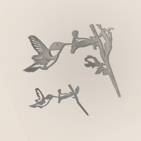 The Hummingbird Mom & Mini Set features two gray metal hummingbirds feeding from flowers on branches, set against a neutral background—a delightful garden gift for nature lovers.