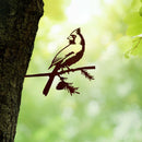 Cardinal bird silhouette in Corten steel perched on a pine branch, a striking outdoor bird sculpture for garden and memorial spaces.