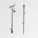 Minimalist wall art featuring two black branches: the left branch has a Chickadee, inspired by the Metalbird Seconds - Chickadee Plant Stake, perched on top with berries below; the right branch is bare, set against a plain white background.