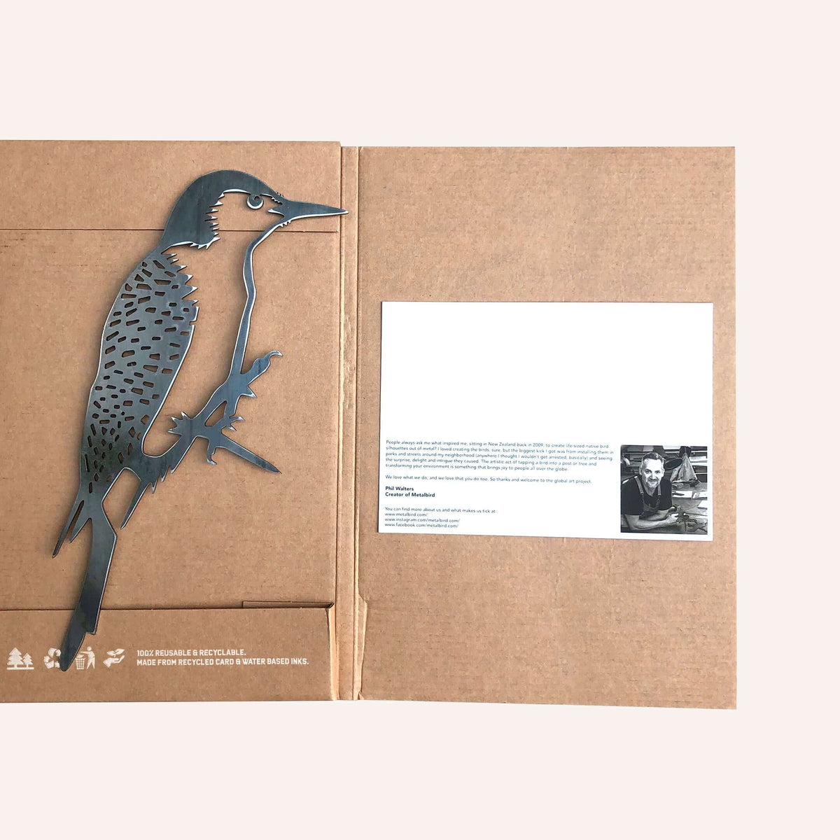 Woodpecker silhouette beside opened Metalbird packaging and printed card.