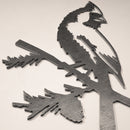 Close-up of raw Corten steel cardinal silhouette with pine detail, a handcrafted outdoor bird sculpture for garden or memorial use.