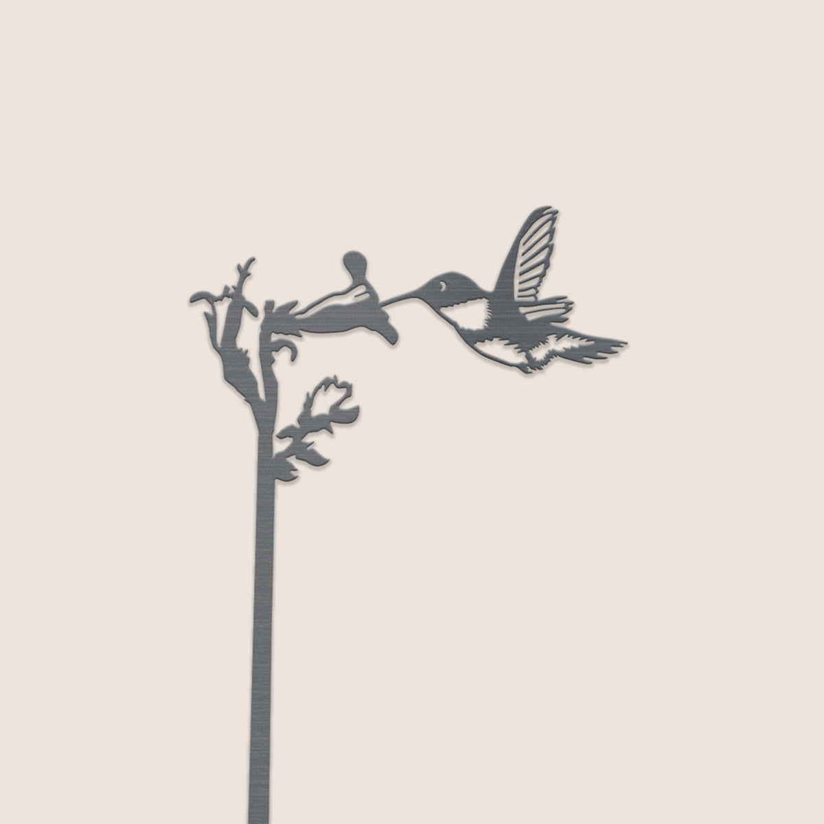 Close-up of the hummingbird and flower detail at the top of the steel plant stake.