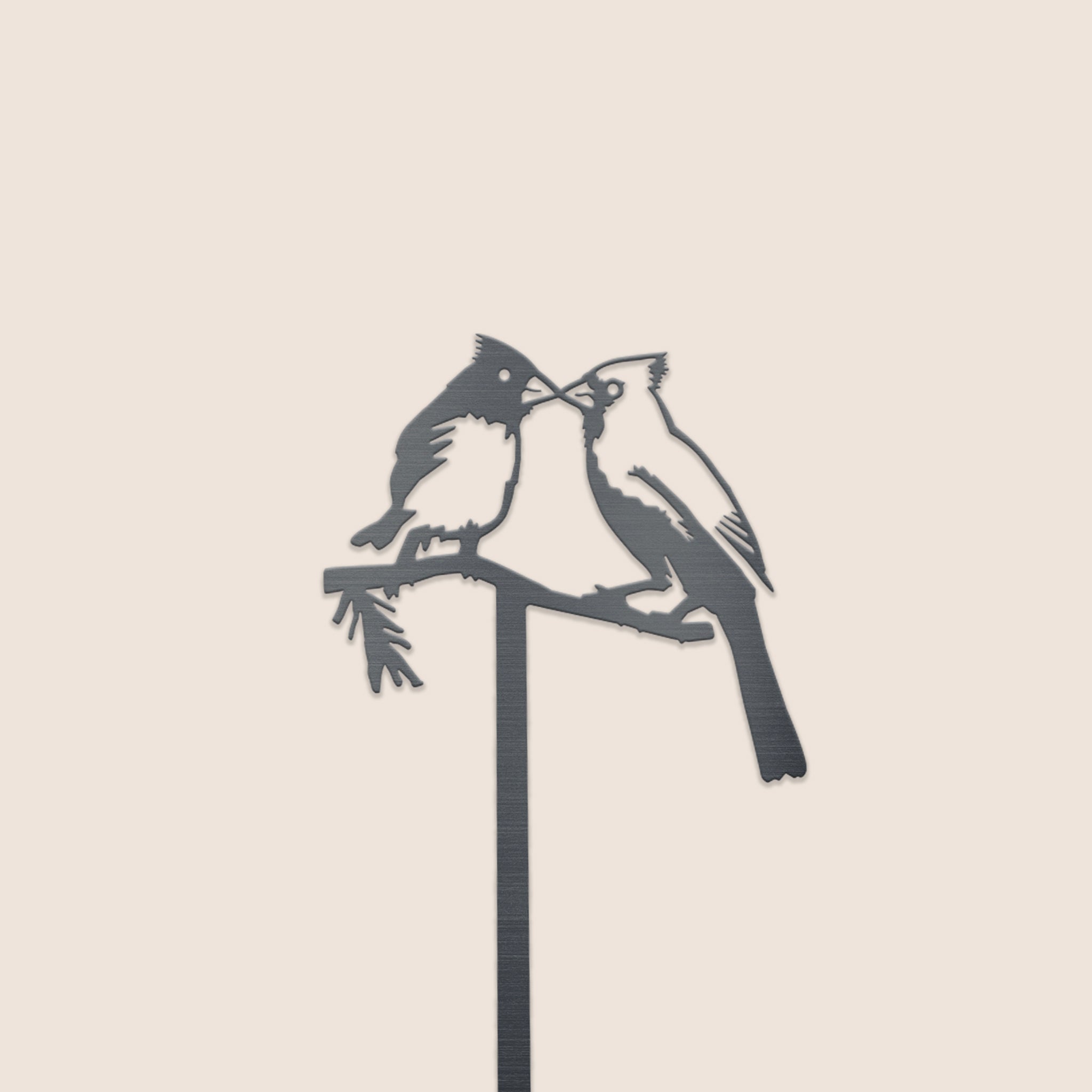 The Kissing Cardinals Plant Stake - 25" features two cardinals perched beak-to-beak on a branch, crafted from durable Corten steel and perfect for adding romantic silhouette art to your garden or outdoor space.
