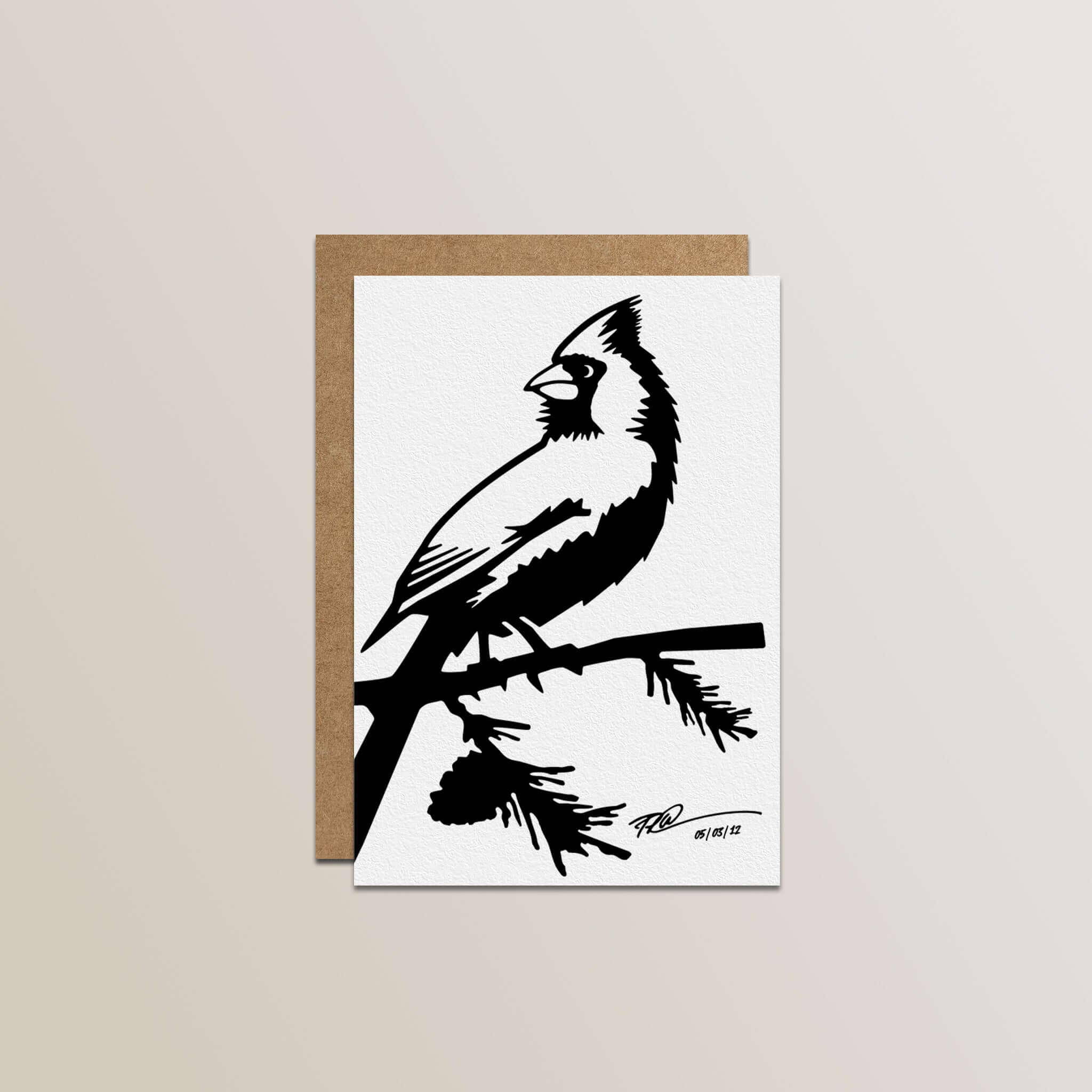 The Metalbird Greeting Card Set features a premium card with a black and white silhouette of a cardinal on a branch, paired with a brown envelope, all displayed on a light background.