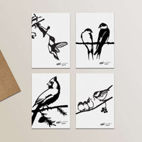 The Metalbird Greeting Card Set features four minimalist black and white bird illustrations, each on a separate card in bold line art style, perfect for corten steel or metal yard art inspiration. Cards are displayed in a neat grid on a light surface.