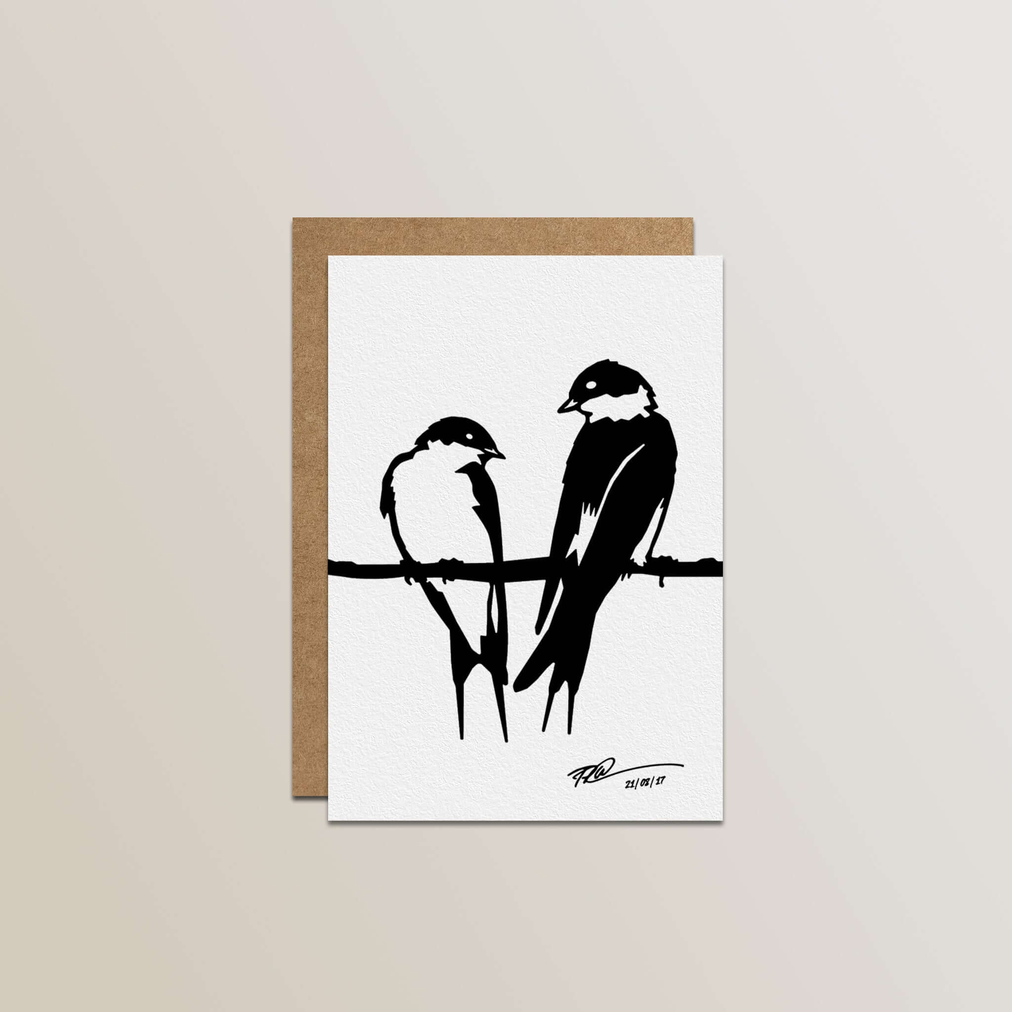 The Metalbird Greeting Card Set features a premium card with a black and white silhouette of two birds on a branch, paired with a brown envelope, displayed against a light neutral background.